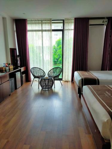 Ένα ή περισσότερα κρεβάτια σε δωμάτιο στο Camellia Hotel