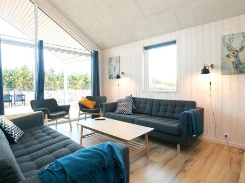 a living room with couches and a table at 5 star holiday home in Jerup in Jerup
