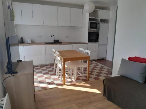a kitchen with a table and chairs in a room at Maison de pêcheurs in Ault