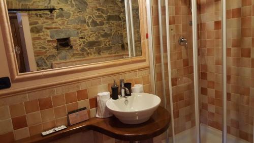 a bathroom with a sink and a shower at Tangohotel in Lucca