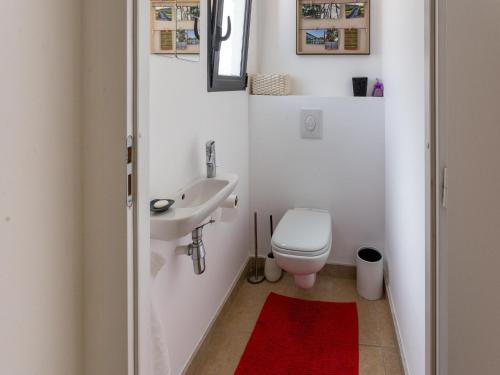 a white bathroom with a toilet and a sink at Villa in Malaucène with Mont Ventoux Views in Malaucène