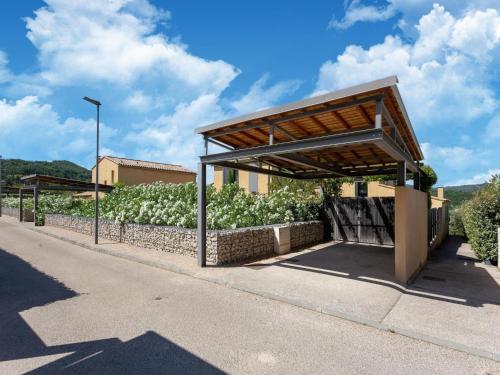a bus stop with awning on the side of a road at Villa in Malaucène with Mont Ventoux Views in Malaucène