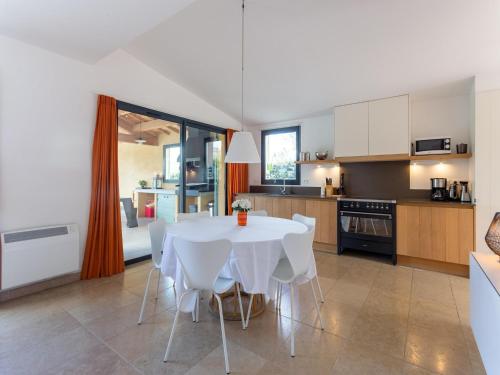 a kitchen with a white table and white chairs at Villa in Malaucène with Mont Ventoux Views in Malaucène