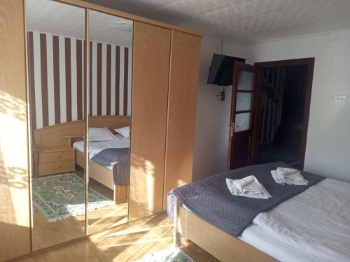 a bedroom with two beds and a glass wall at Casa Cornelia in Bran