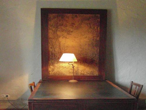 a lamp sitting on top of a table in a room at Castle in Le Veurdre near Forest and River in Le Veurdre