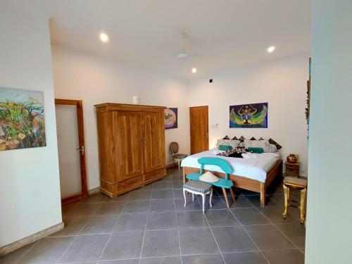 a bedroom with a bed and a table and chairs at Skylodge B&B - Bali Jungle Retreat with Fine Dining & Eco Pool in Bukti