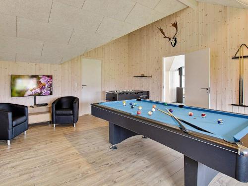 a billiard room with a pool table and two chairs at 5 star holiday home in Faaborg in Bøjden