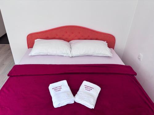 a bed with two white pillows on it at Apartman Sofija in Teslić