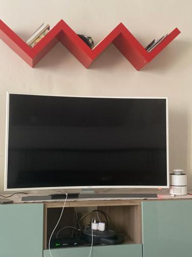 a flat screen tv sitting on top of a shelf at La Casetta sul Lago in Viverone