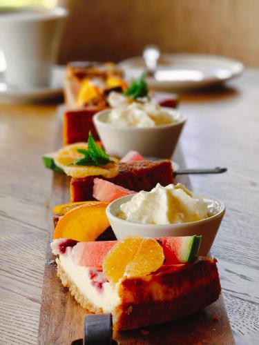 a group of sandwiches with fruit and dip on a table at Boutique Hotel het Witte Veen in Witteveen