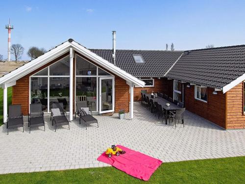a house with a patio with tables and chairs at 5 star holiday home in Kappeln in Kappeln