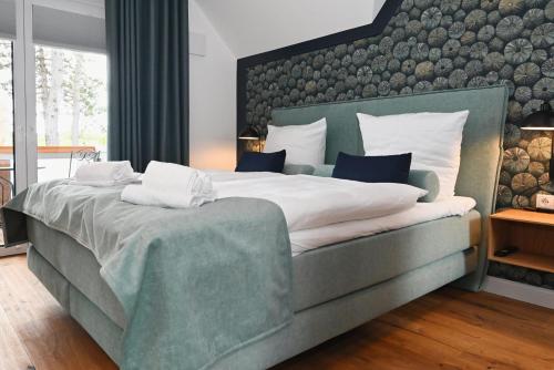 a bedroom with a large bed with a large headboard at Pidder-Lyng Haus 3 in Böhl
