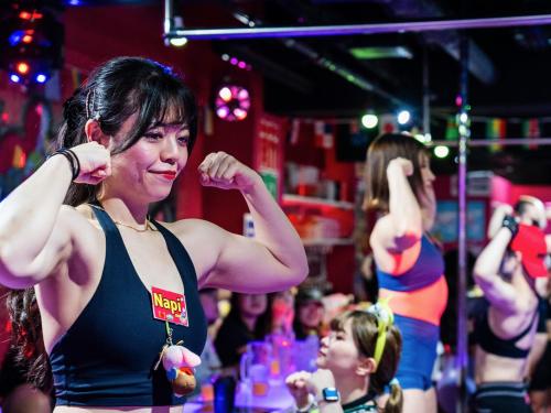 a woman standing in front of a crowd at a party at Tokyu Stay Ikebukuro in Tokyo