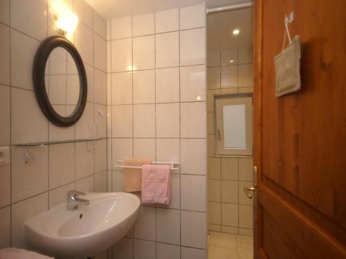 a white bathroom with a sink and a mirror at Apartment in Riquewihr near Vineyards in Riquewihr