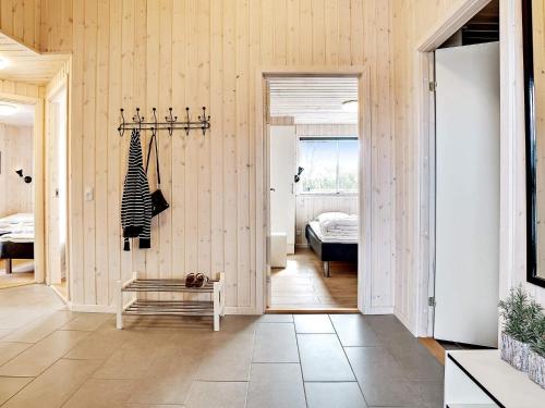 a hallway with wood paneled walls and a bedroom at 26 person holiday home in Grenaa in Grenå