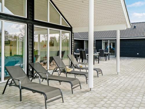 a group of chairs sitting in front of a building at 26 person holiday home in Grenaa in Grenå