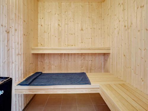 a sauna with a bed in a wooden room at 26 person holiday home in Grenaa in Grenå