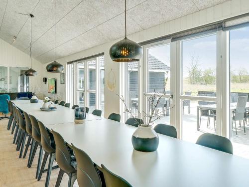 a conference room with a long table and chairs at 26 person holiday home in Grenaa in Grenå