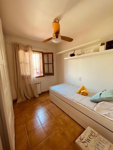 a bedroom with a bed and a ceiling fan at Casa en Sant Antoni de Calonge in Calonge
