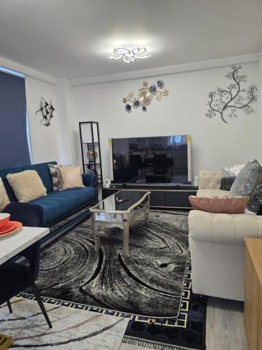 a living room with a blue couch and a fireplace at Mega3 Central Manchester Luxury 2-Bedroom,2-Baths with Free Car Park in Manchester