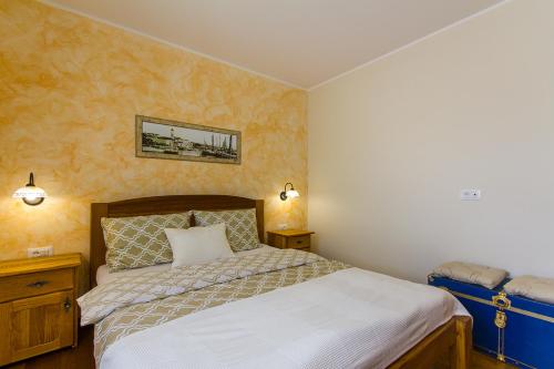 a bedroom with a large bed with white sheets at Villa Luca with pool and jacuzzi in Vrh