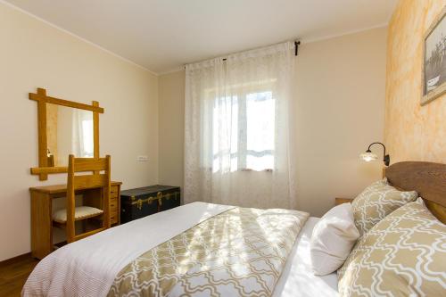 a bedroom with a bed and a window at Villa Luca with pool and jacuzzi in Vrh