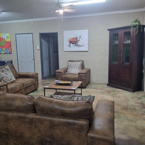 a living room with couches and a coffee table at Onse Boshuis in Marloth Park