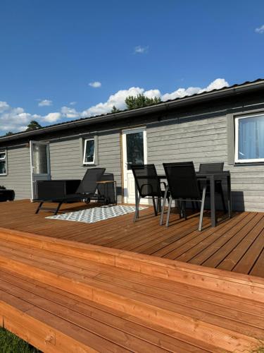 a deck with chairs and a table on a house at Summer house Sunny coast in Lankstiņi