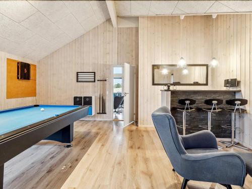 a room with a pool table and two chairs at Luxury Pool Retreat - By Traum Ferienwohnungen in Vejby