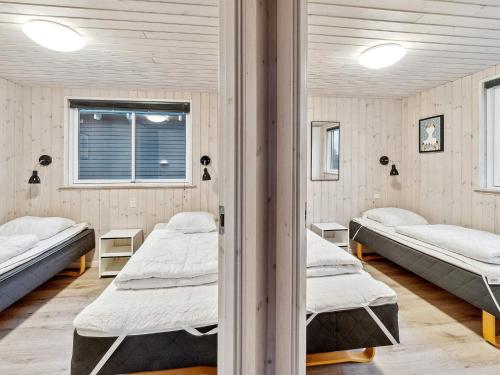 a room with three beds and a window at Luxury Pool Retreat - By Traum Ferienwohnungen in Vejby