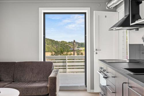 a kitchen with a couch and a large window at Sandefjord 1 bedroom kitchen and bathroom - Non smoking in Sandefjord