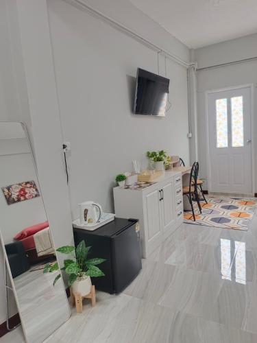 a living room with a kitchen and a dining room at The little home in Bangkok