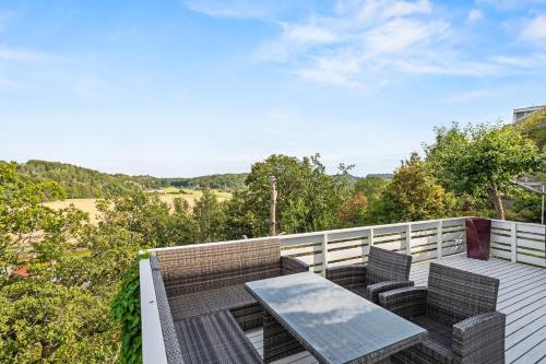 a patio with a table and chairs on a balcony at Sandefjord 1 bedroom kitchen and bathroom - Non smoking in Sandefjord