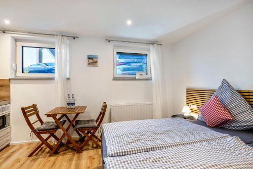 a bedroom with a bed and a table and chairs at Gemütlich Privat Zimmer in Reutlingen