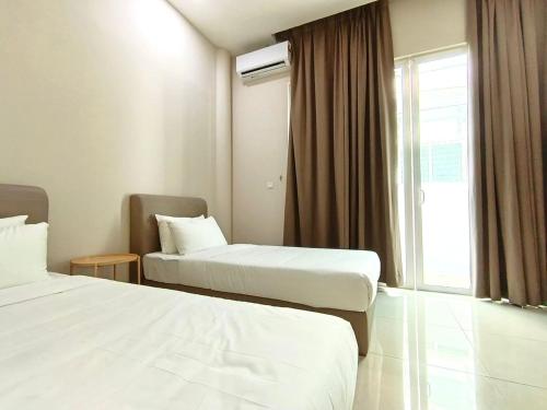 a hotel room with two beds and a window at myRoom at 11, Jalan Adams Georgetown in George Town
