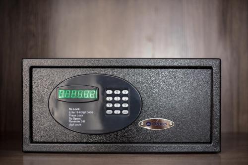 a small television with a clock on top of it at Sensory Park Urban Hotel in Phnom Penh