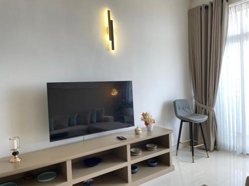 a living room with a couch and a television at Marine Blue Apartment in Dehiwala