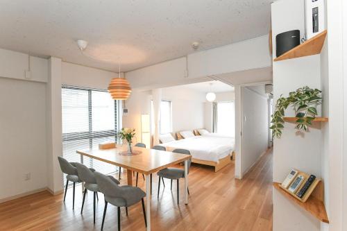 a dining room and living room with a table and chairs at 灯Akari KAMAKURA in Kamakura