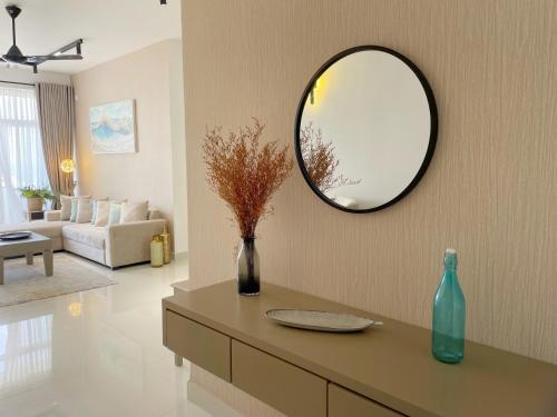 a living room with a mirror on the wall at Marine Blue Apartment in Dehiwala