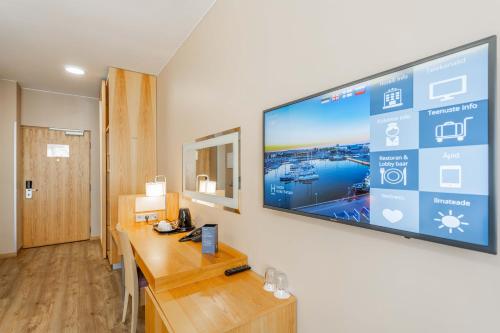 a room with a large flat screen tv on a wall at Hestia Hotel Europa in Tallinn