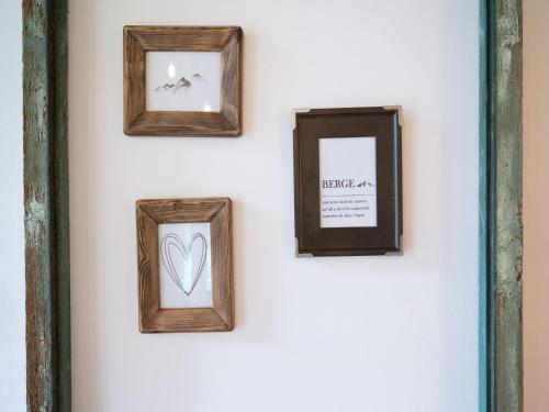four frames hanging on a white wall at Lush apartment in Sankt Michael ob Bleiburg in Sankt Michael ob Bleiburg