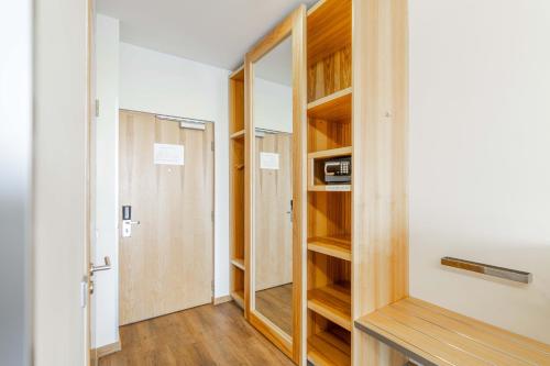 a room with a closet with wooden shelves at Hestia Hotel Europa in Tallinn