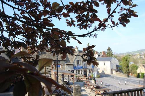 a view of a town with benches and a street at The Clothiers Arms in Stroud