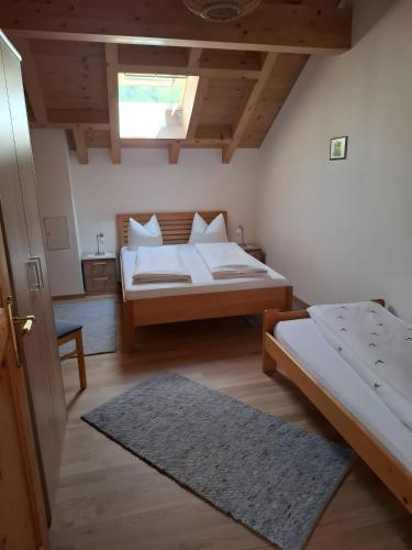 a bedroom with two beds and a window at Haus Vögel in Sibratsgfäll