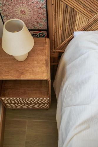a bedroom with a bed and a lamp on a night stand at VIELA Guest House Premium in Barcelos