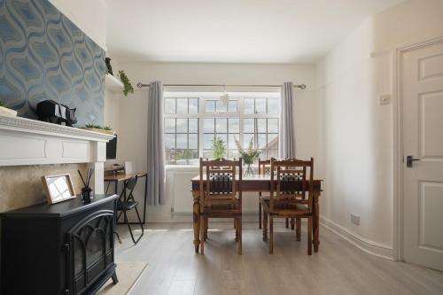 a dining room with a table and chairs and a window at poplar in Mexborough