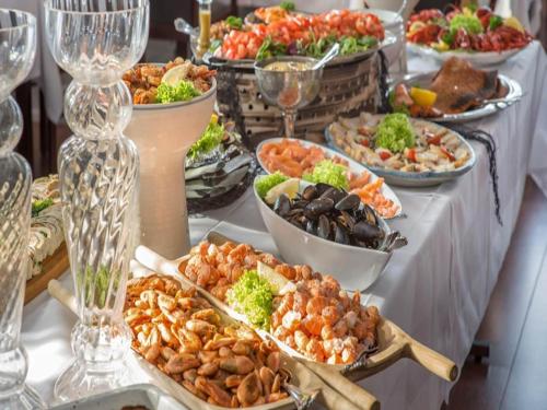 a buffet with many plates of food on a table at Luxury Beach House - By Traum Ferienwohnungen in Bagenkop
