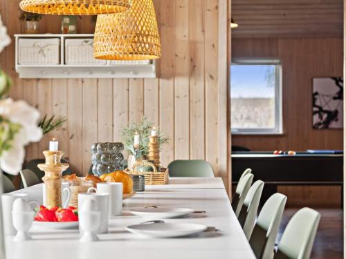 a dining room table with a white tablecloth and fruit on it at Luxury Beach House - By Traum Ferienwohnungen in Bagenkop