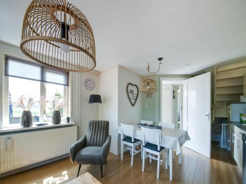 a kitchen and dining room with a table and chairs at Beautiful Apartment in Callantsoog near Beach in Callantsoog