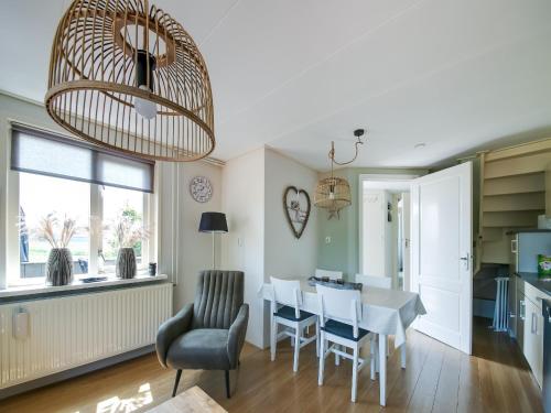 a kitchen and dining room with a table and chairs at Beautiful Apartment in Callantsoog near Beach in Callantsoog